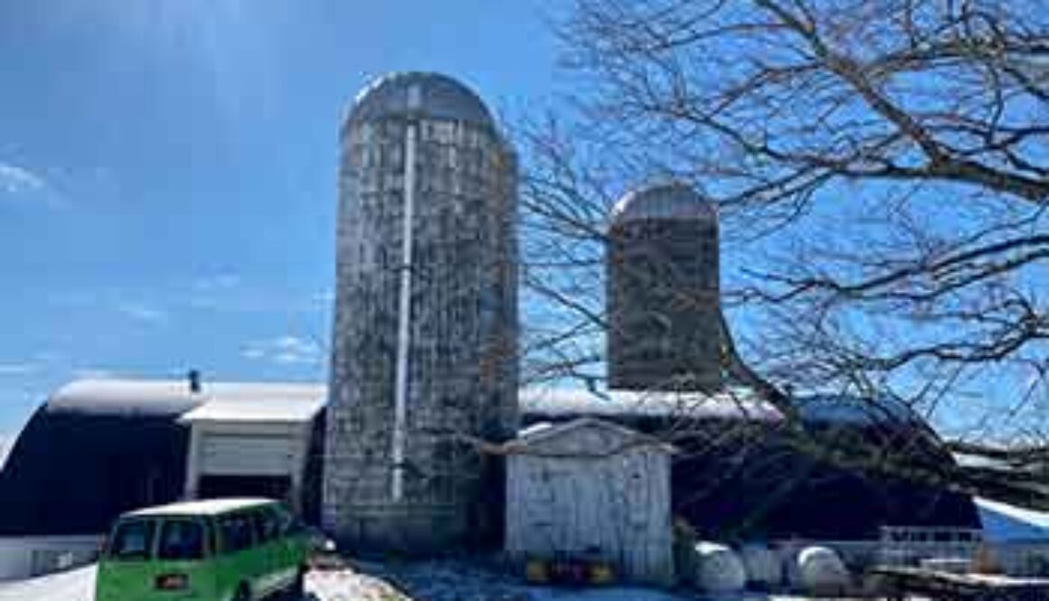 Hilltop Hanover farm in winter snow covered buildings