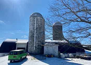 Hilltop Hanover farm in winter snow covered buildings
