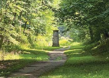 croton-point-trails dirt path in woods leading to sculpture