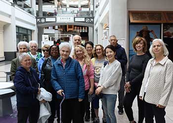 group of men and women in mall ready to walk