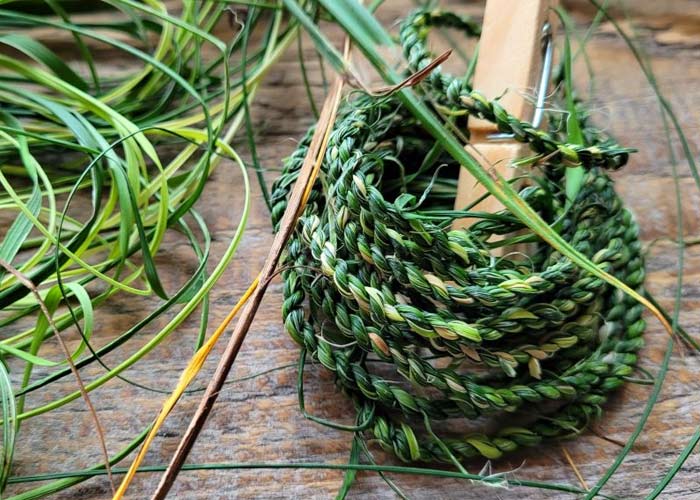cord created from plants wrapped around stick