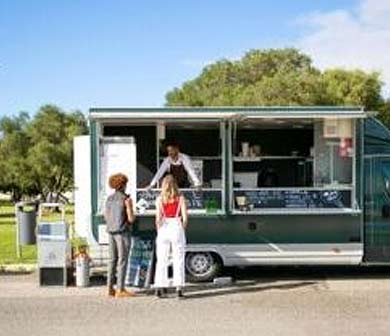 two girls getting food from food truck