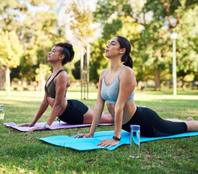 two women posing on mat doing pilates