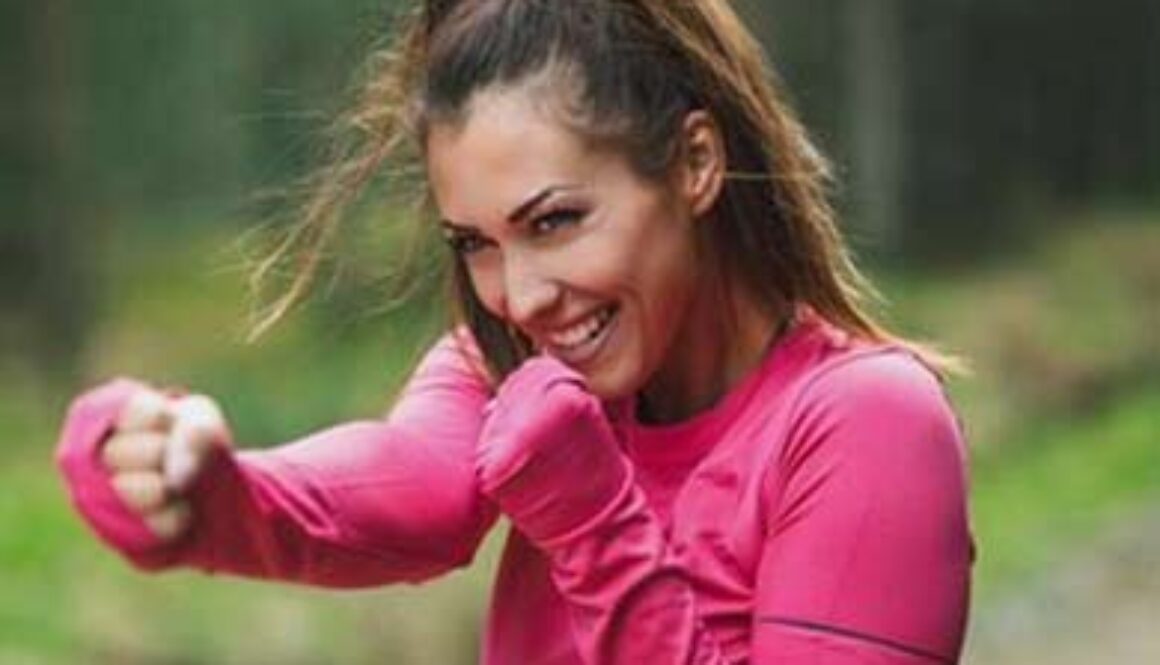 woman in pink sweatshirt shadow boxing