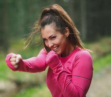 woman in pink sweatshirt shadow boxing