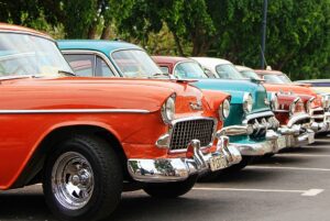 classic cars line up in parking lot
