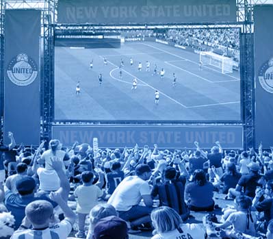 crowd of people watching soccer on huge screen