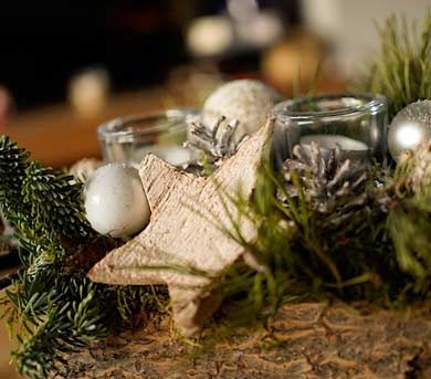 arrangement of candles, greens and star