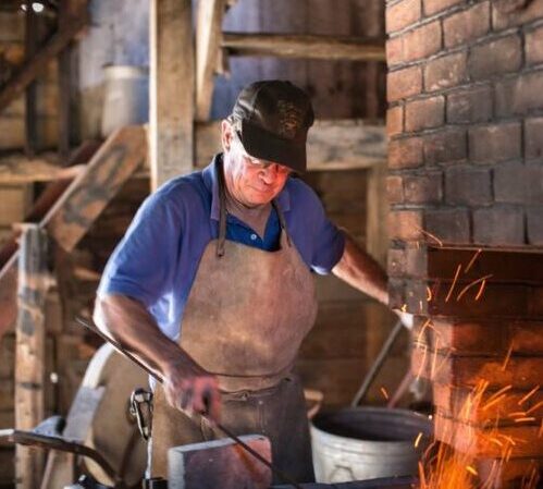 blacksmith working iron over fire